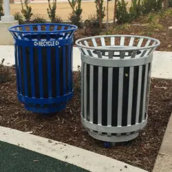 Two trash cans: one blue and one black-and-white striped.