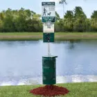 Pet waste station by a lake.