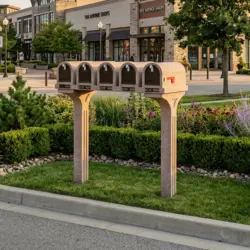 Mailbox in a landscaped area near a shopping center.