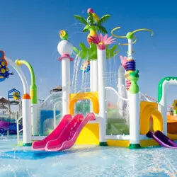 Water park playground with colorful slides and sprays.