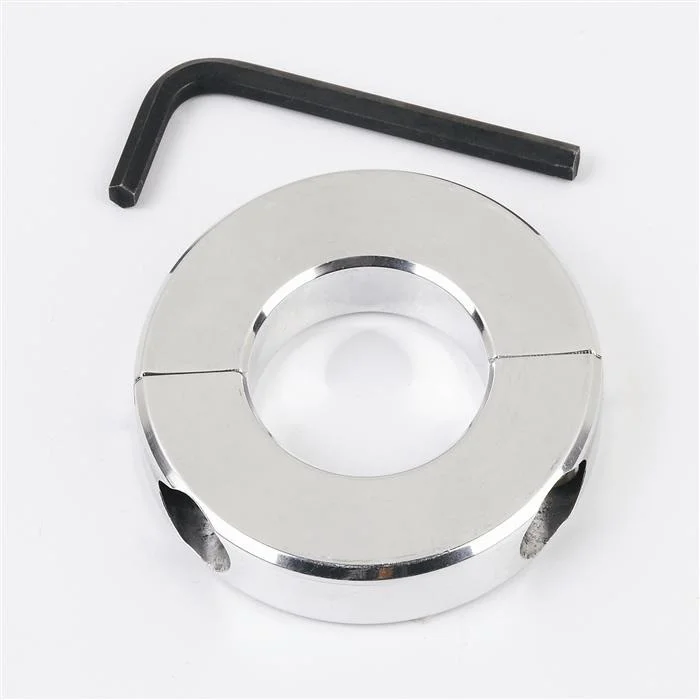 Silver-colored circular object with a central hole and two side holes.