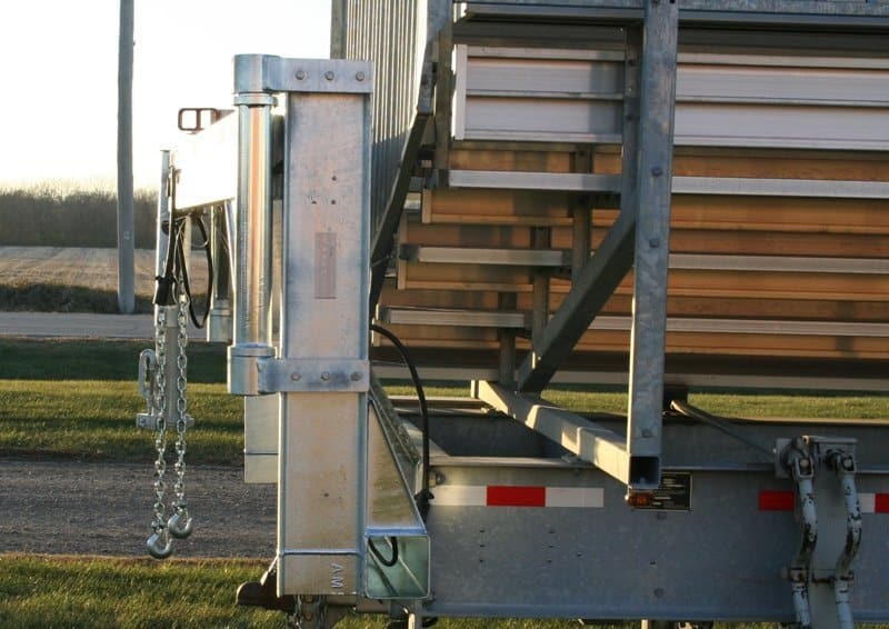 Metal trailer with steps and hooks.