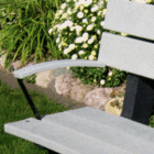 White bench in a garden setting.