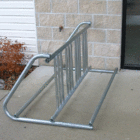 Bicycle rack on concrete outside a building.