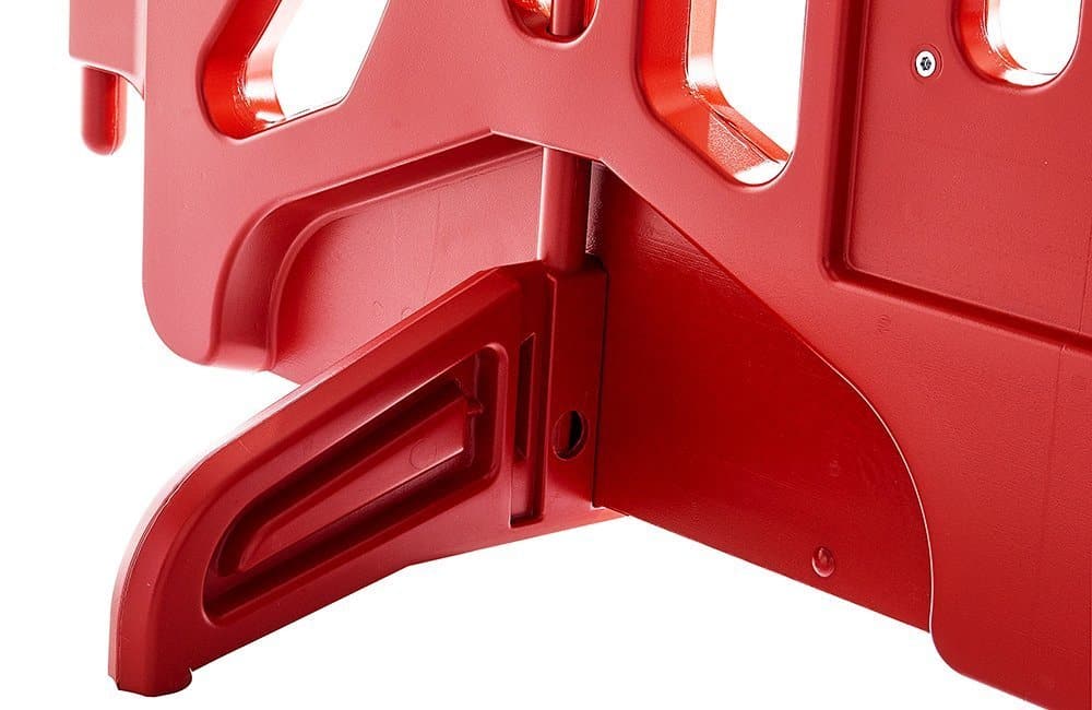 Red plastic object with cutouts and handles.