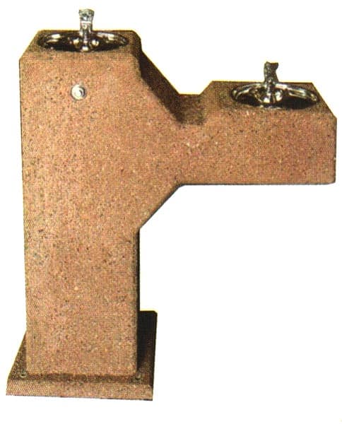 Concrete drinking fountain with two spouts.