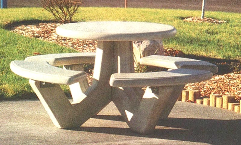 Outdoor picnic table with curved seats and a round top.
