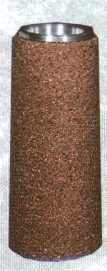 Cylindrical object with textured surface and metallic top.