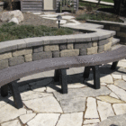 Outdoor stone bench on a patio.