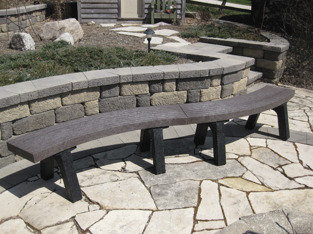 Outdoor stone bench on a patio.
