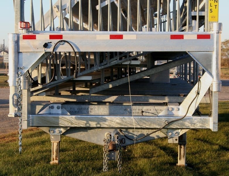 Metal loading ramp on grassy area.