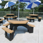 Outdoor picnic tables with blue and white umbrellas.