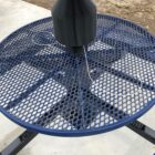 Blue mesh table with umbrella base.
