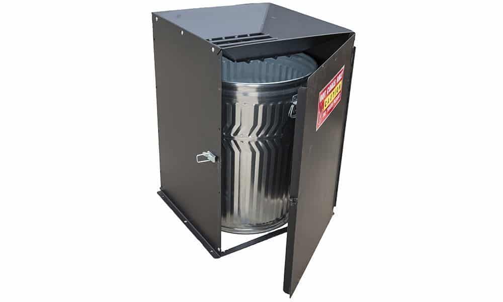 Metal trash can in a black metal enclosure.