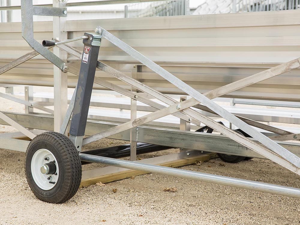 Metal trailer ramp on gravel surface.