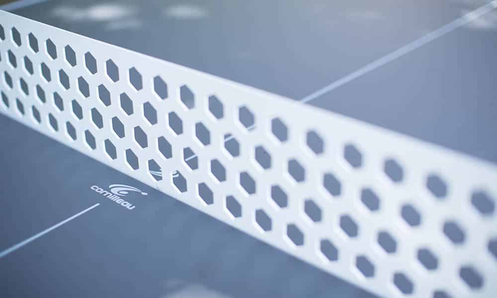 Close-up view of a perforated table tennis net.