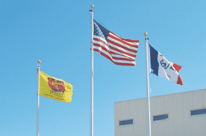 Flags flying in front of a building.