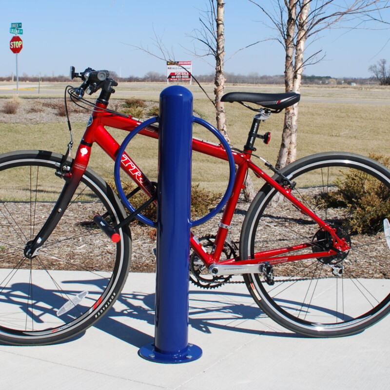 Red bicycle parked on a blue bike rack.