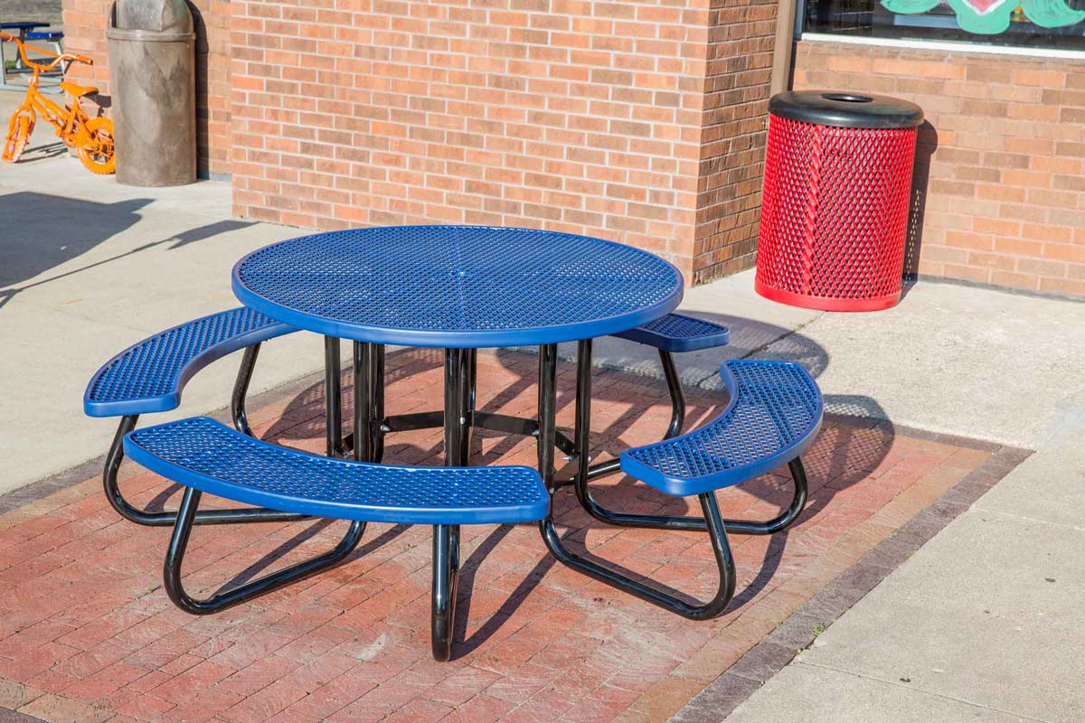 Outdoor blue round picnic table with curved bench seating.