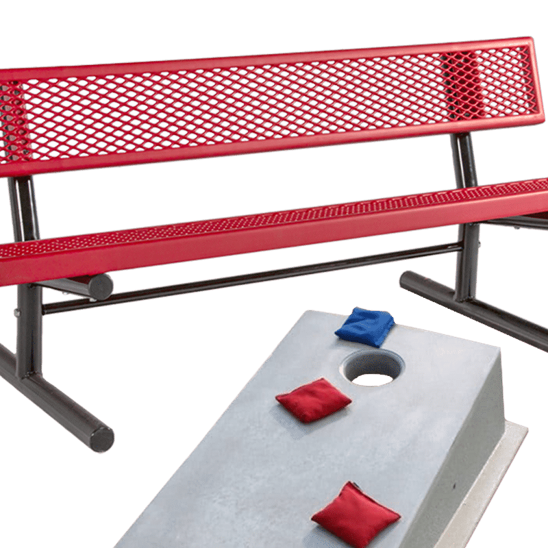 Red metal bench and bean bag toss table on green background.