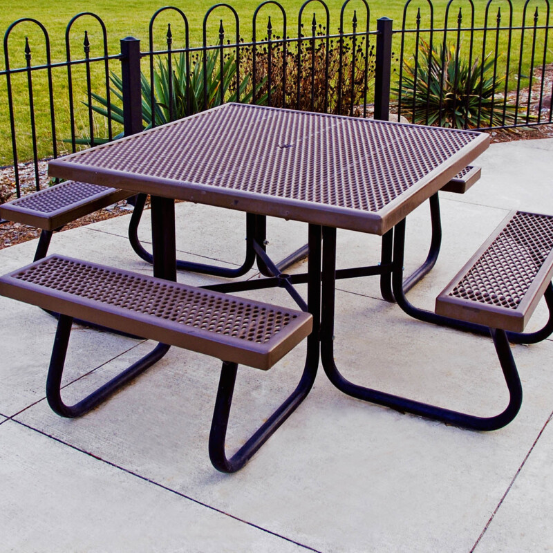 Outdoor picnic table with perforated metal top and benches.