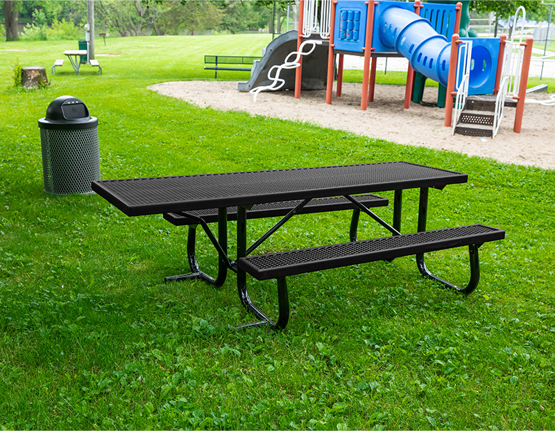 Black picnic table in a park setting.