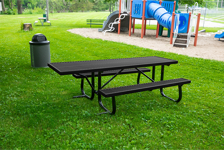 Black picnic table in a park setting.