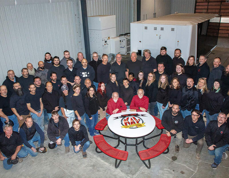 Group photo of employees in a warehouse.