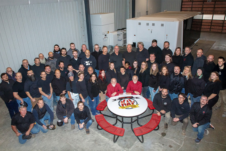 Group photo of employees in a warehouse.